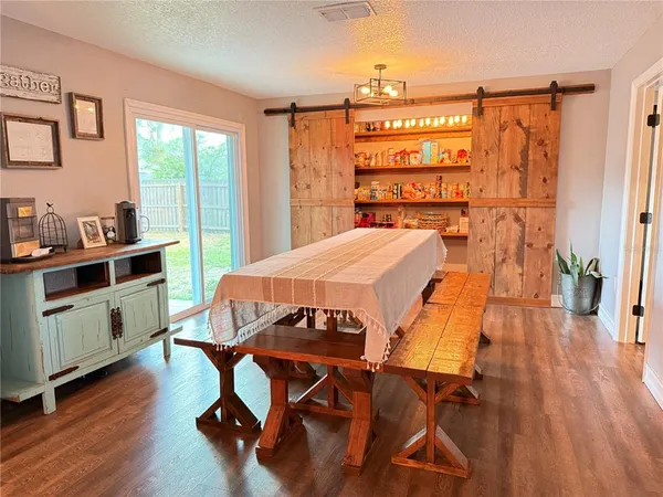 a view of a dining room with furniture and wooden floor