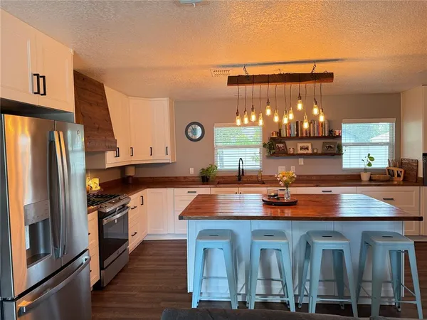 a kitchen with lots of counter top space and stainless steel appliances