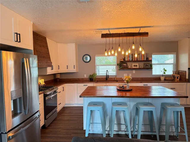 a kitchen with lots of counter top space and stainless steel appliances