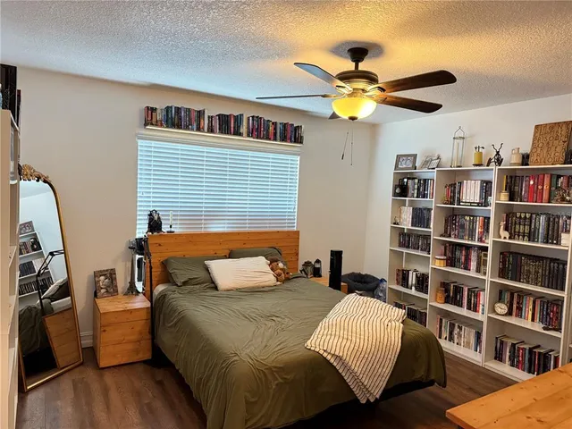 a bedroom with a bed and a book shelf