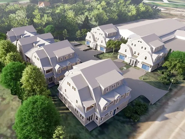 an aerial view of a house with garden space and street view