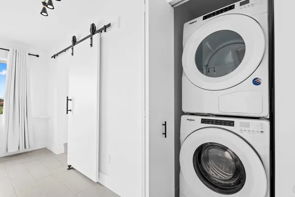 a view of a hallway with washer and dryer