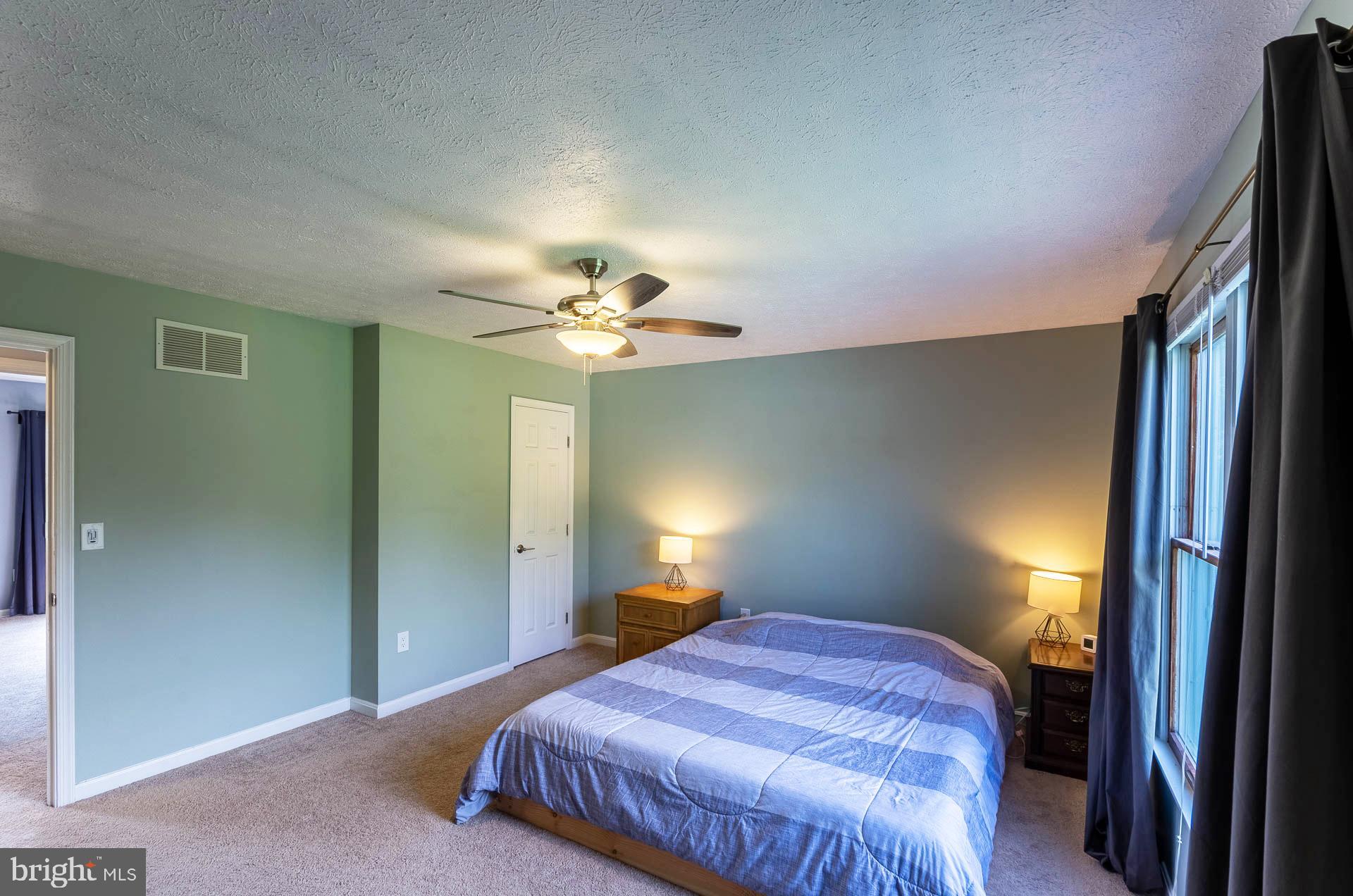 26 Liddell Road Colora, MD 21917 - Photo 19 of 37 a bedroom with a bed and a chandelier