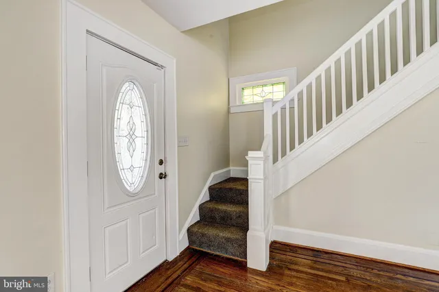 a view of an entryway with wooden floor