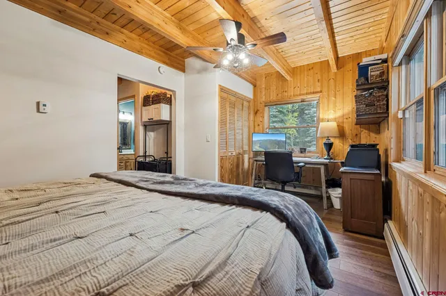 a bed sitting in a bedroom next to a window