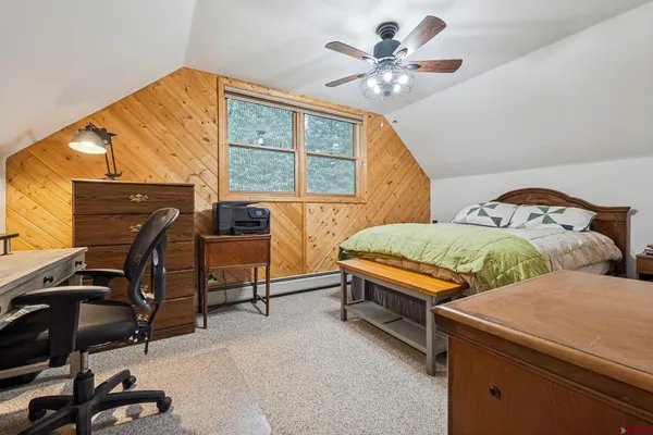 a bedroom with two beds and a window