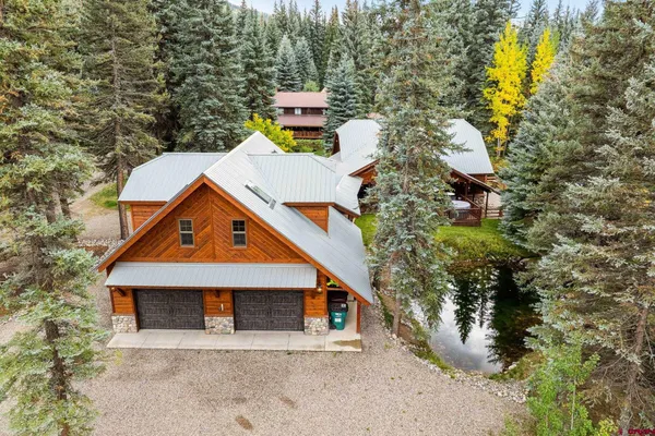 an aerial view of a house with yard