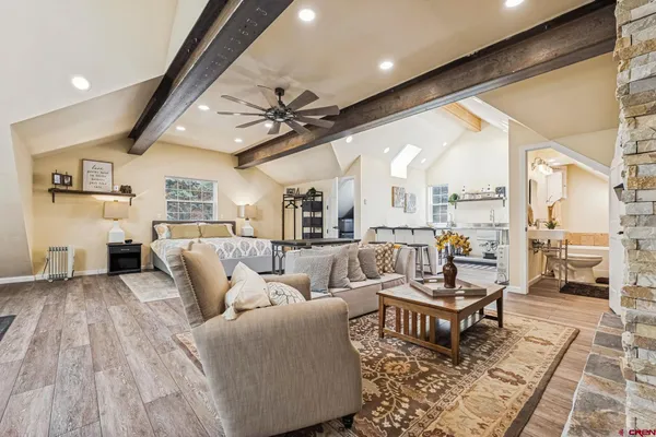 a living room with furniture and wooden floor