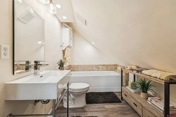 a bathroom with a sink a toilet and bathtub