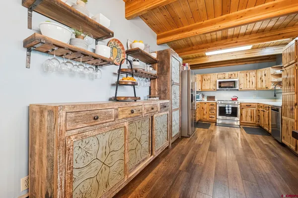 a kitchen with stainless steel appliances a stove top oven and a refrigerator