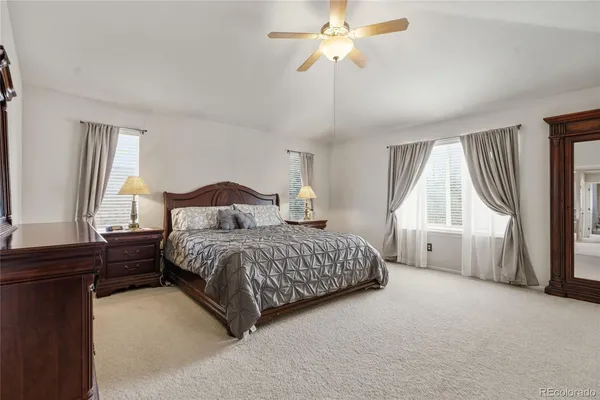 a spacious bedroom with a bed and a window