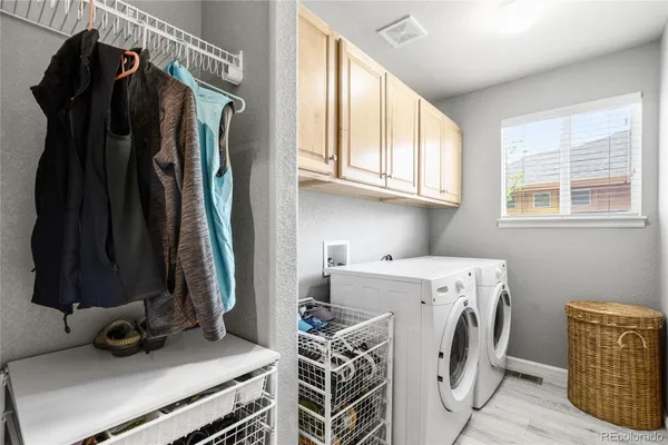 a view of a storage and utility room with washer and dryer