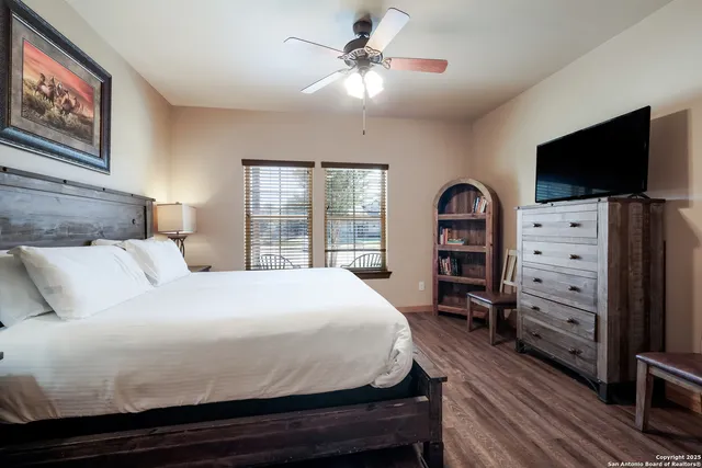 a bedroom with a bed and a flat screen tv