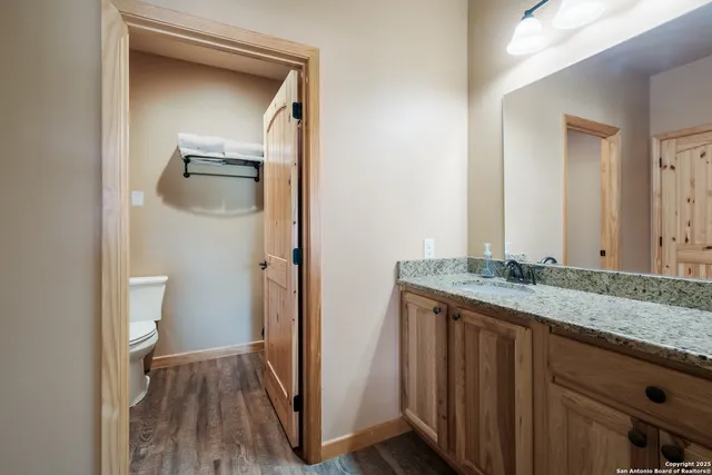 a bathroom with a granite countertop sink and a mirror