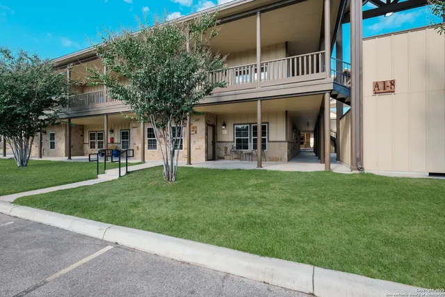 front view of a brick building with a yard