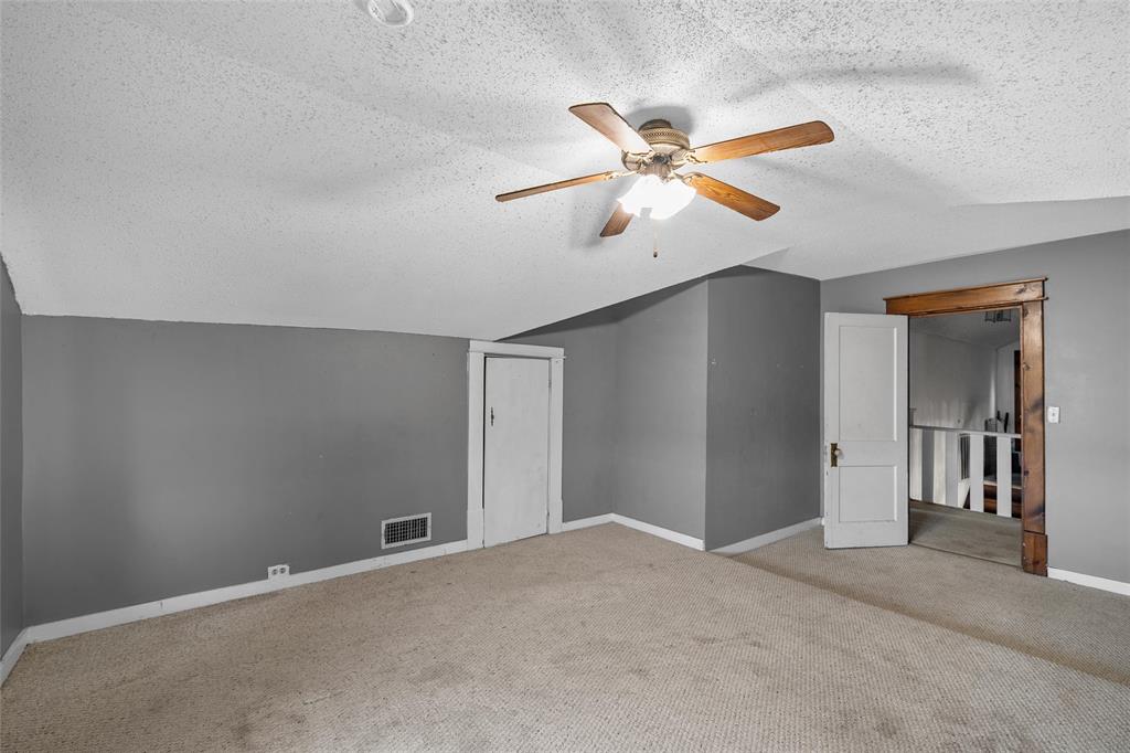 306 South Cleveland Meridian, TX 76665 - Photo 13 of 26 a view of a room with a ceiling fan and carpet