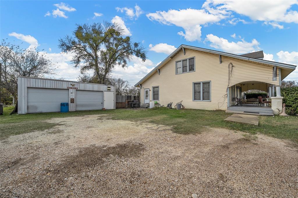 306 South Cleveland Meridian, TX 76665 - Photo 25 of 26 a view of a house with a yard and garage