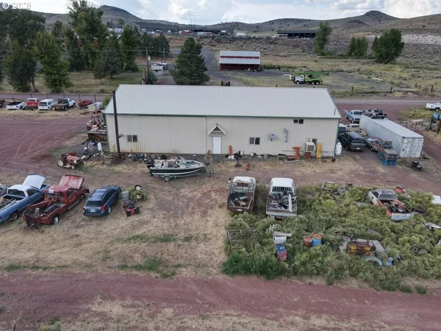 an aerial view of a house with garden space and car parked