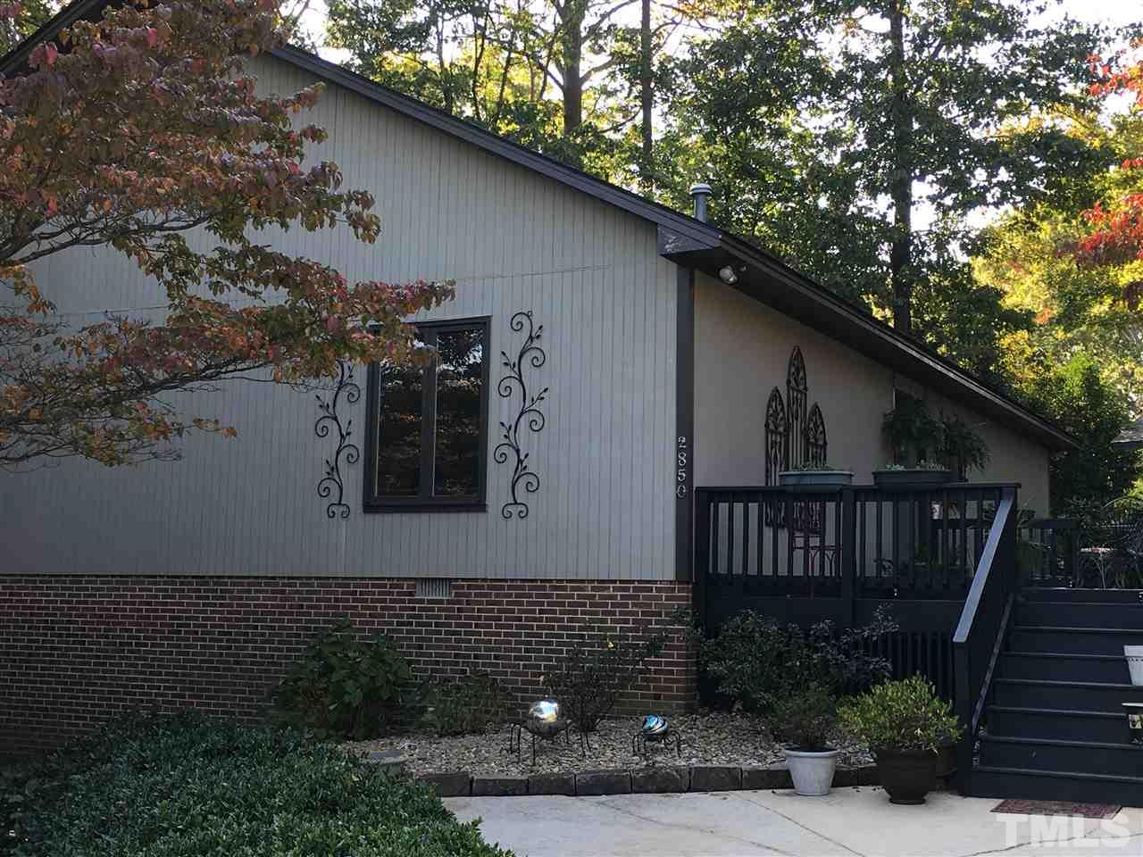 2850 Rue Sans Famille Raleigh, NC 27607 - Photo 1 of 24 a view of backyard with plants and outdoor seating