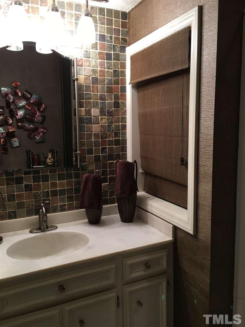 2850 Rue Sans Famille Raleigh, NC 27607 - Photo 18 of 24 a bathroom with a sink and a mirror