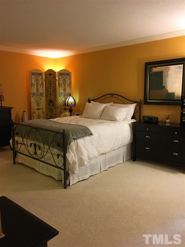 2850 Rue Sans Famille Raleigh, NC 27607 - Photo 21 of 24 a bedroom with a bed and a night stand