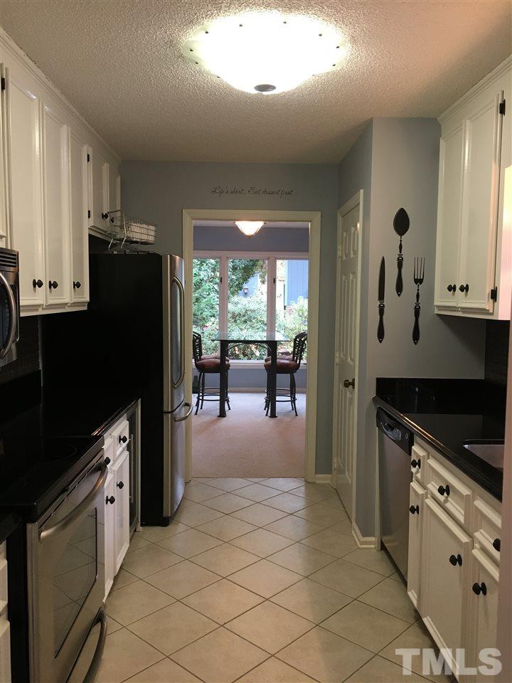 2850 Rue Sans Famille Raleigh, NC 27607 - Photo 10 of 24 a kitchen with granite countertop a refrigerator stove and sink