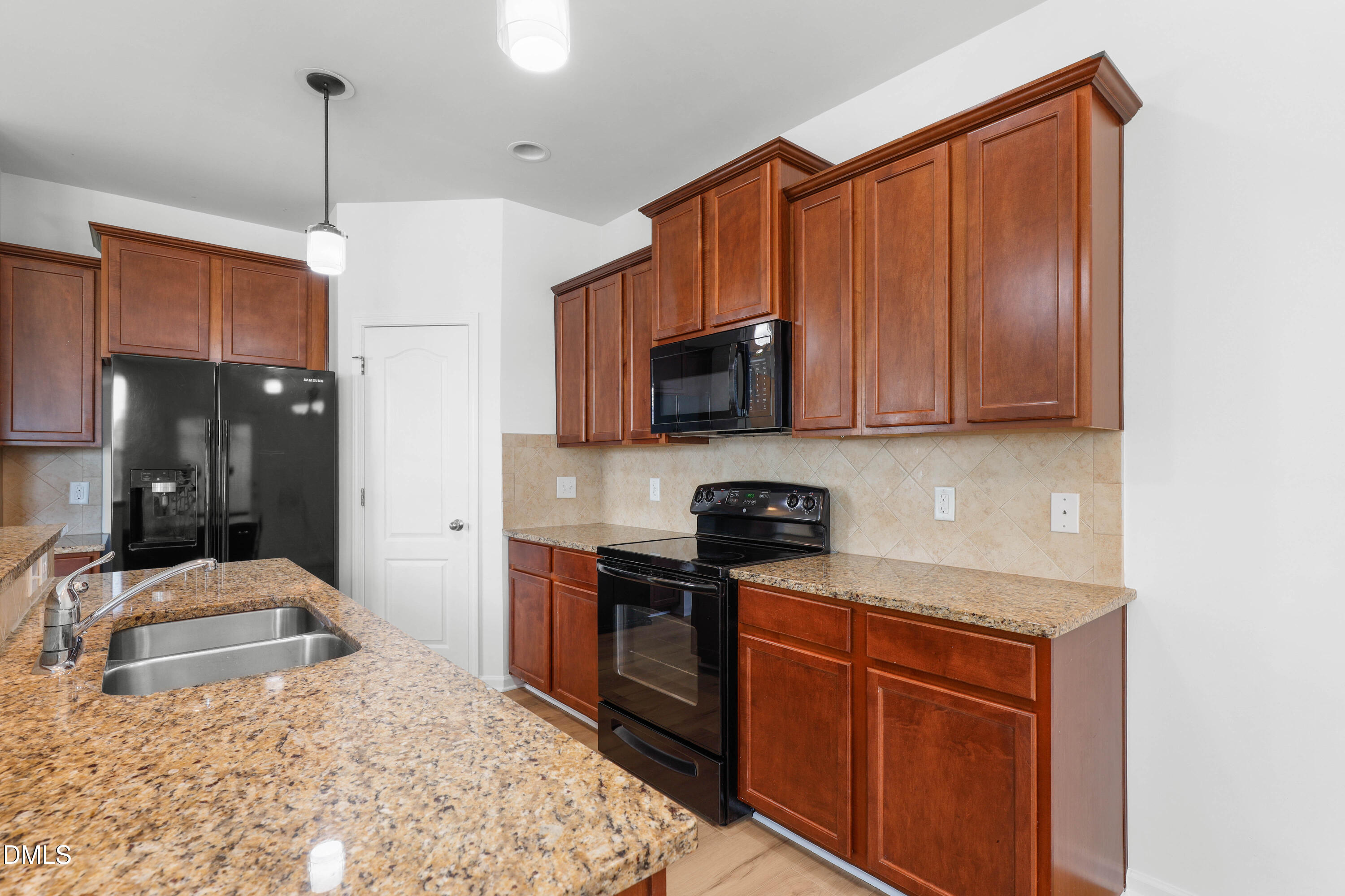 4400 Hillsgrove Road Wake Forest, NC 27587 - Photo 6 of 49 a kitchen with stainless steel appliances granite countertop a sink stove and refrigerator