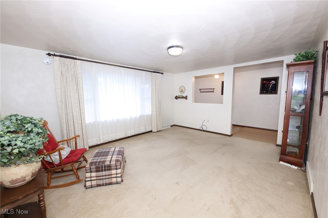 115 Carol Road Wellsburg, WV 26070 - Photo 18 of 36 Living area with light colored carpet and baseboards