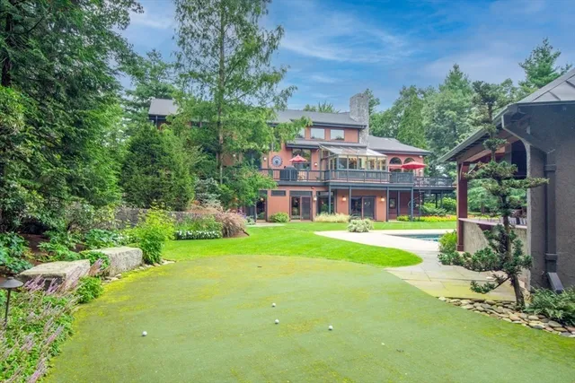 a front view of a house with swimming pool having outdoor seating