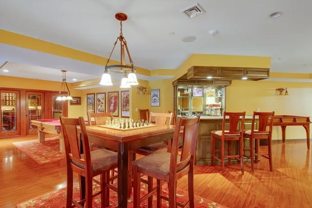a dining hall with lots of furniture and wooden floor