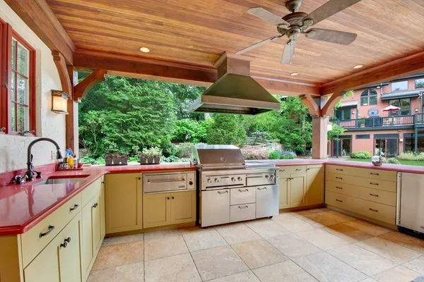 a kitchen with a stove a sink and a window