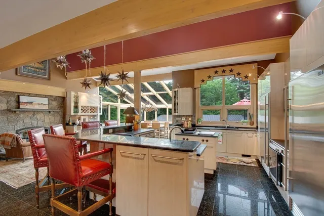 a dining room with stainless steel appliances granite countertop a stove and a refrigerator
