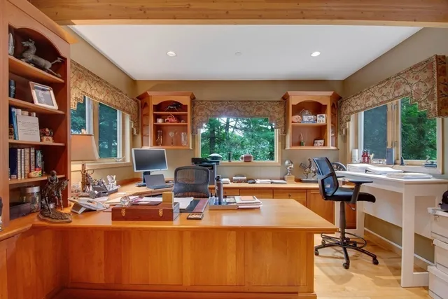 a living room with fireplace furniture and a large window