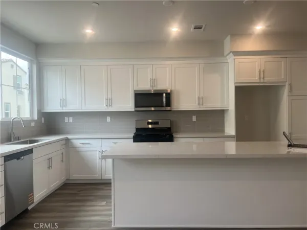 a kitchen with a sink and cabinets