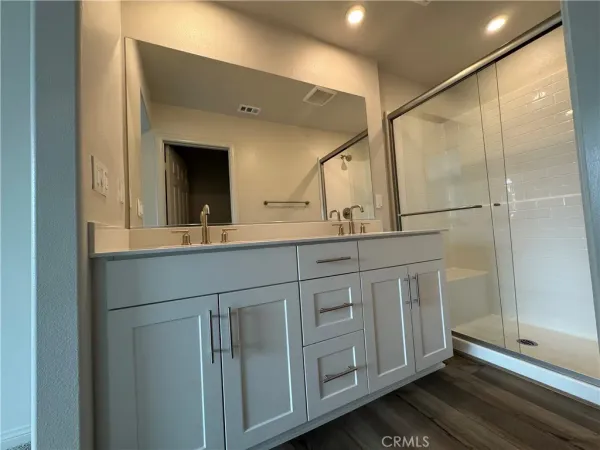 a bathroom with a double vanity sink and mirror