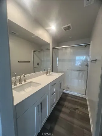 a bathroom with a double vanity sink and a mirror