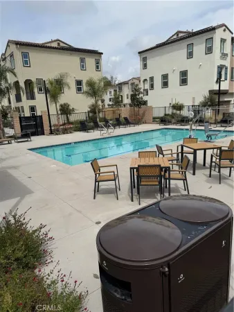 a swimming pool with outdoor seating and yard