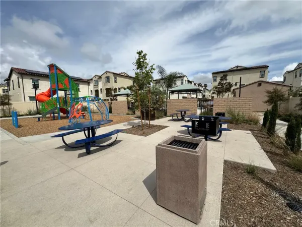a living room with furniture a flat screen tv and a table