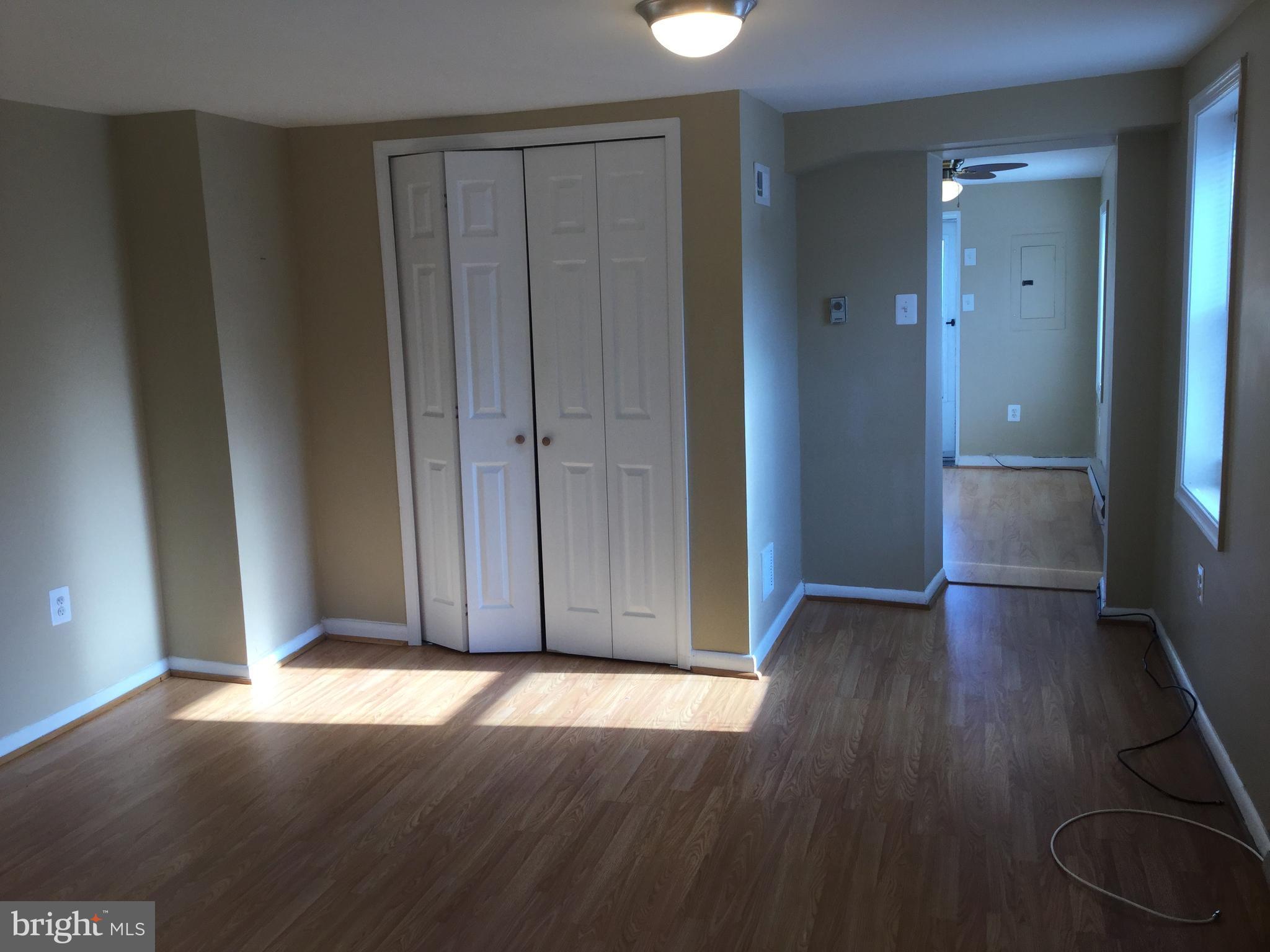1725 Light Street Baltimore, MD 21230 - Photo 4 of 10 an empty room with wooden floor and closet