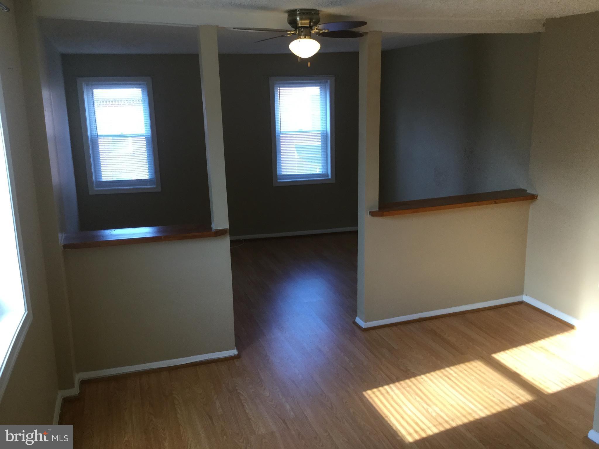 1725 Light Street Baltimore, MD 21230 - Photo 5 of 10 an empty room with wooden floor and windows