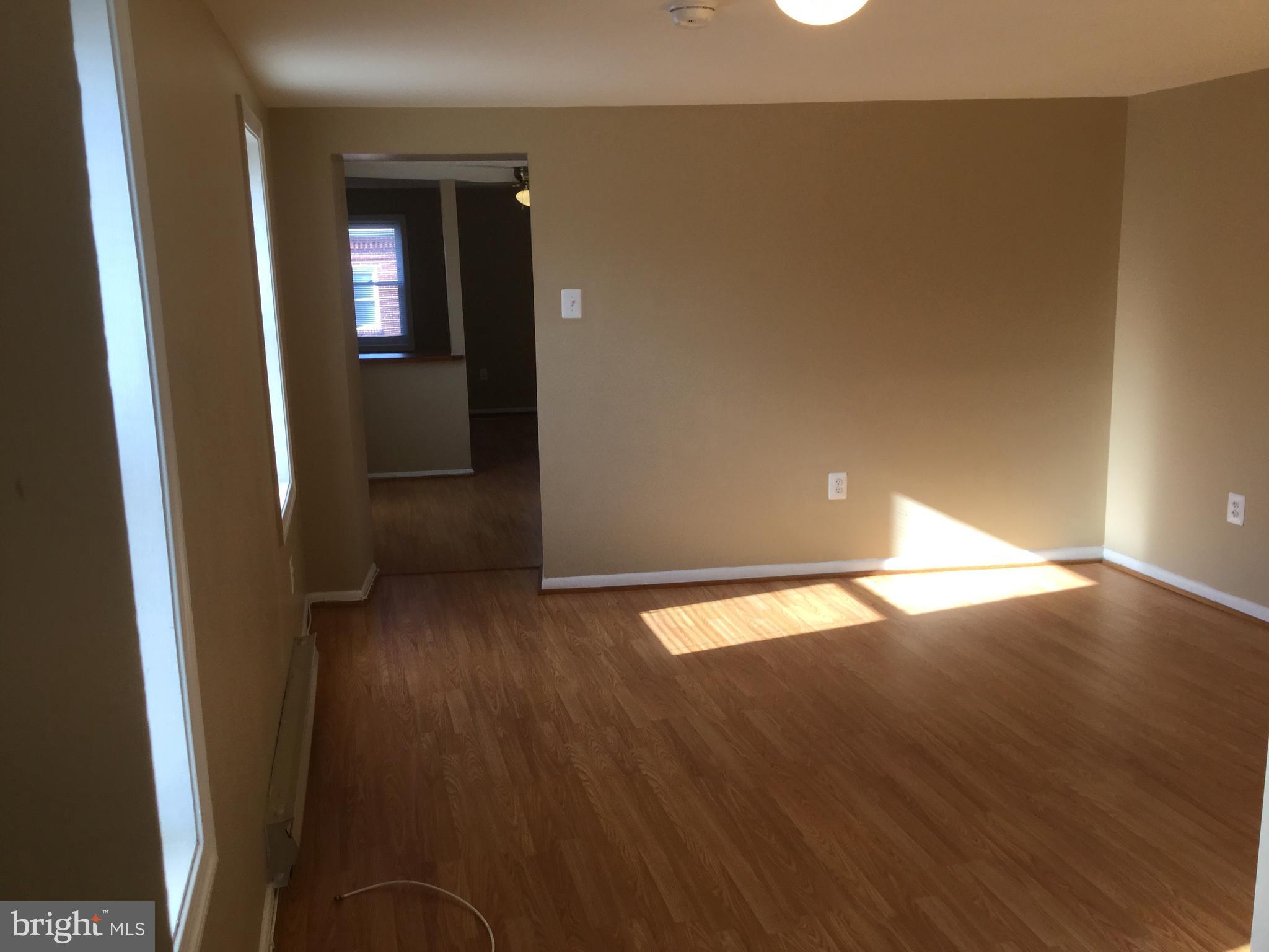1725 Light Street Baltimore, MD 21230 - Photo 7 of 10 an empty room with wooden floor and closet