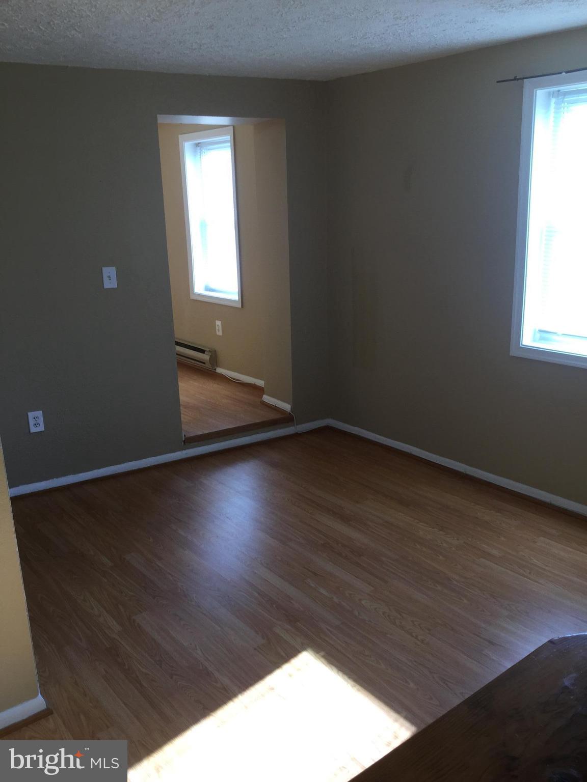 1725 Light Street Baltimore, MD 21230 - Photo 8 of 10 an empty room with wooden floor and windows
