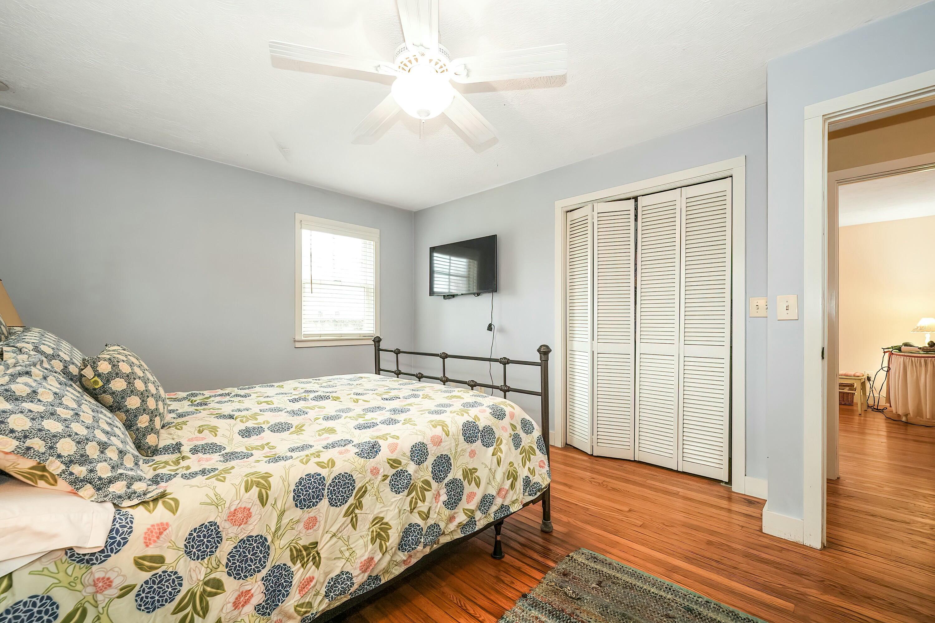 24 Beechwood Road Centerville, MA 02632 - Photo 13 of 33 a bedroom with a large bed chandelier and a window