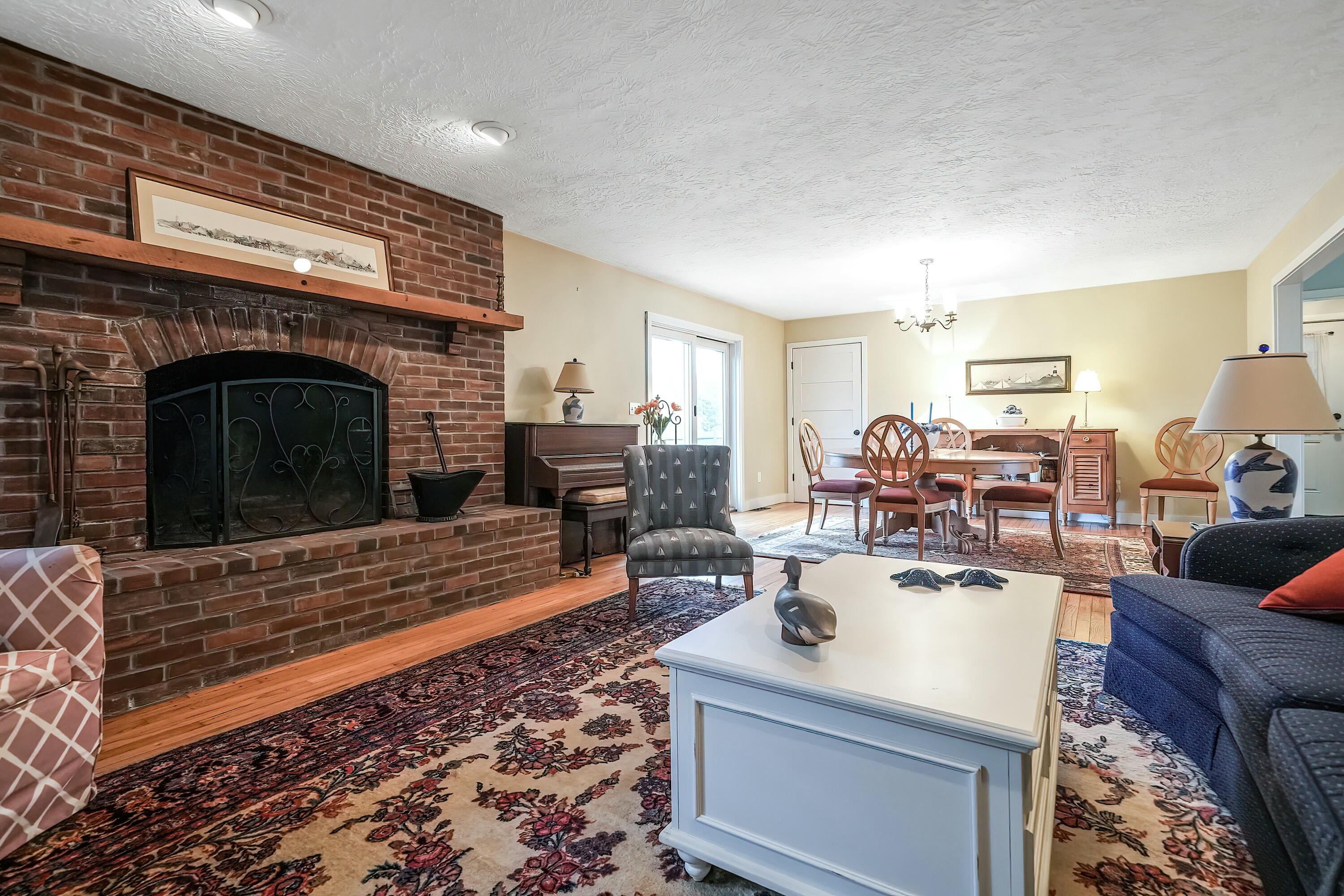 24 Beechwood Road Centerville, MA 02632 - Photo 3 of 33 a living room with furniture and a fireplace
