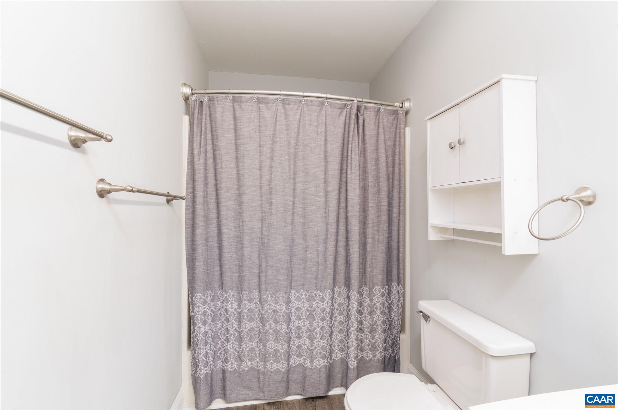 342 Westfield Road Charlottesville, VA 22901 - Photo 17 of 23 a bathroom with a shower curtain and a toilet