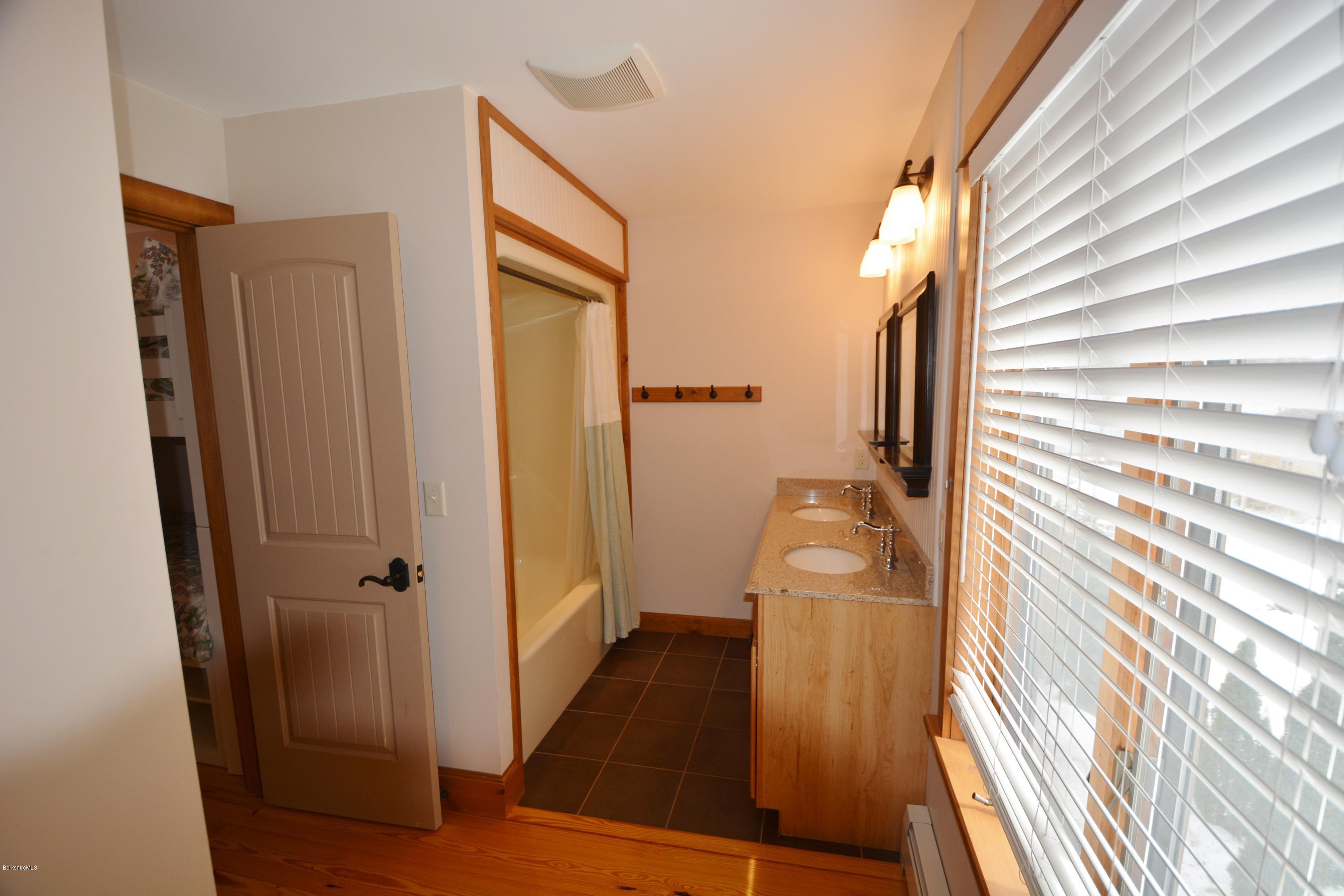 9 Old Stagecoach Road Otis, MA 01029 - Photo 12 of 17 a bathroom with a sink and glass door shower