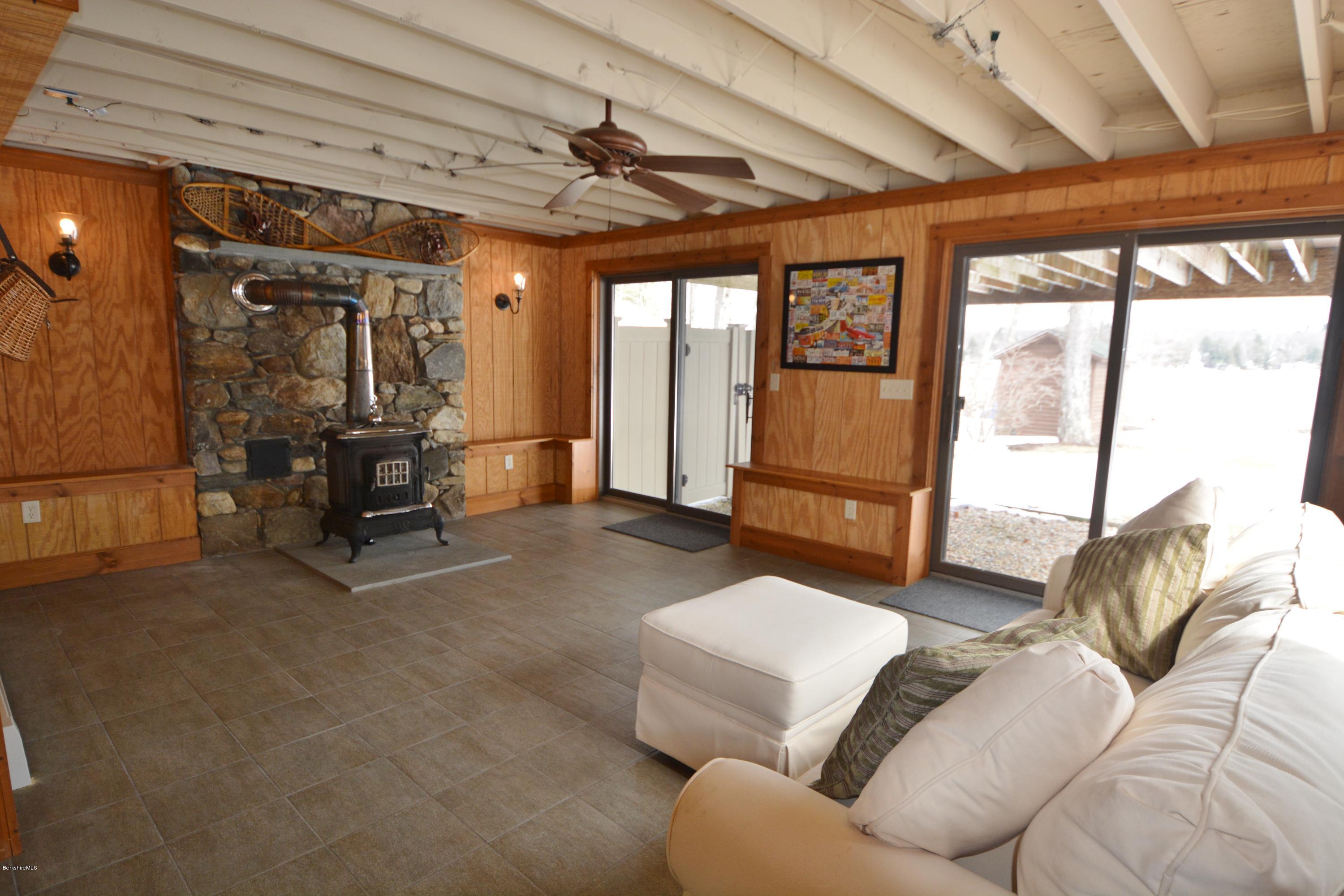 9 Old Stagecoach Road Otis, MA 01029 - Photo 13 of 17 a living room with furniture and a flat screen tv