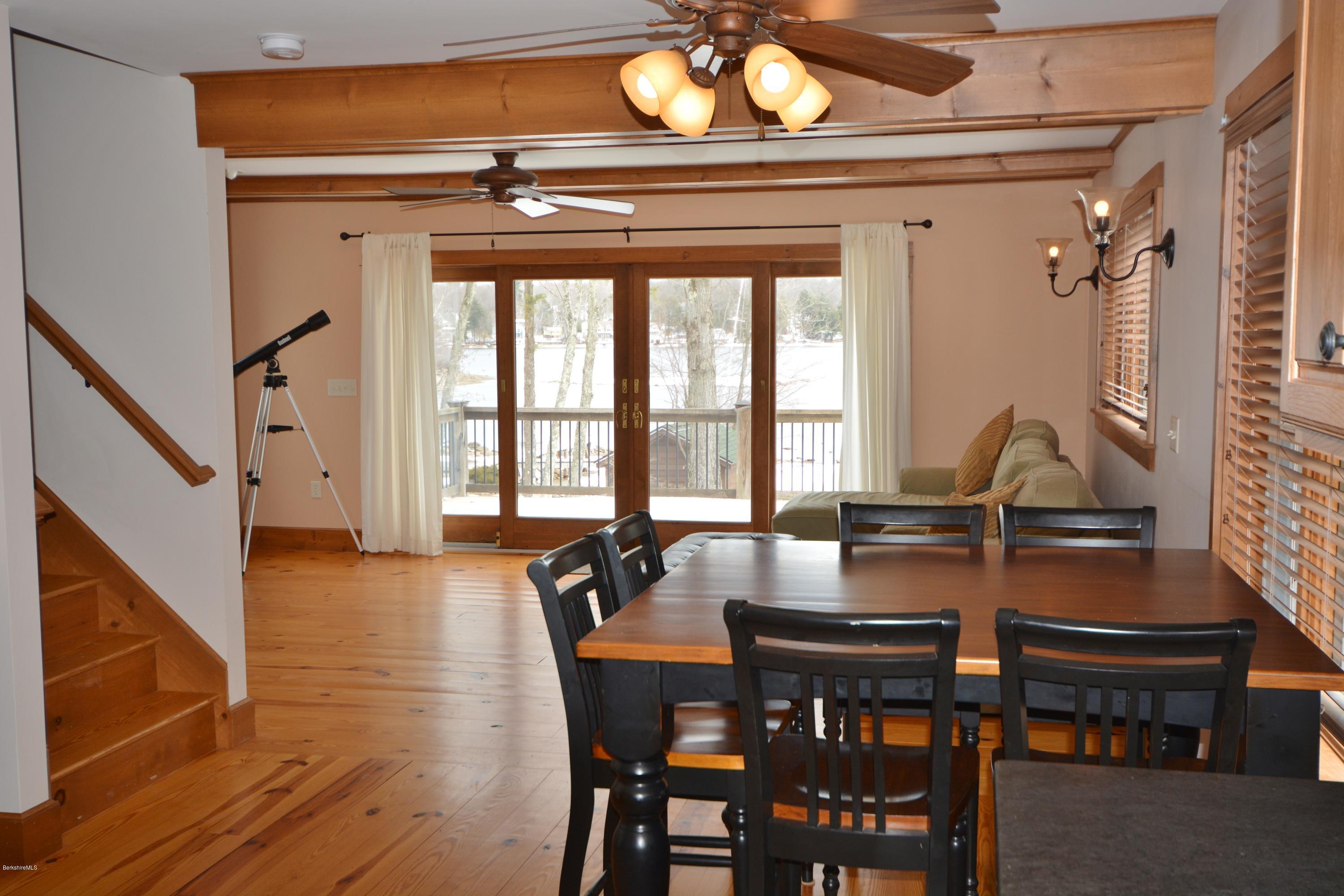 9 Old Stagecoach Road Otis, MA 01029 - Photo 6 of 17 a dining room with wooden floor a chandelier a wooden table and chairs