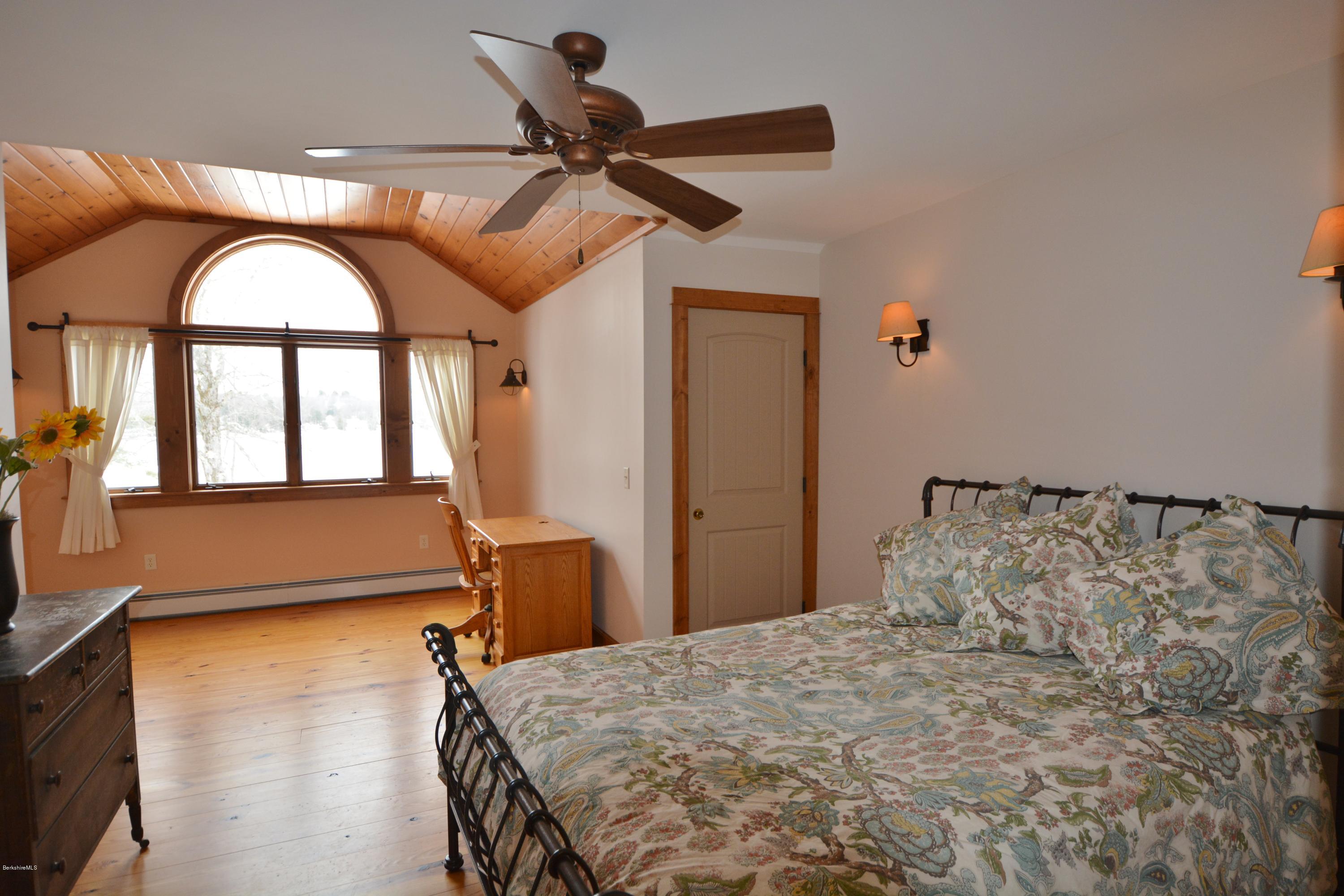 9 Old Stagecoach Road Otis, MA 01029 - Photo 8 of 17 a bedroom with a bed and a large window