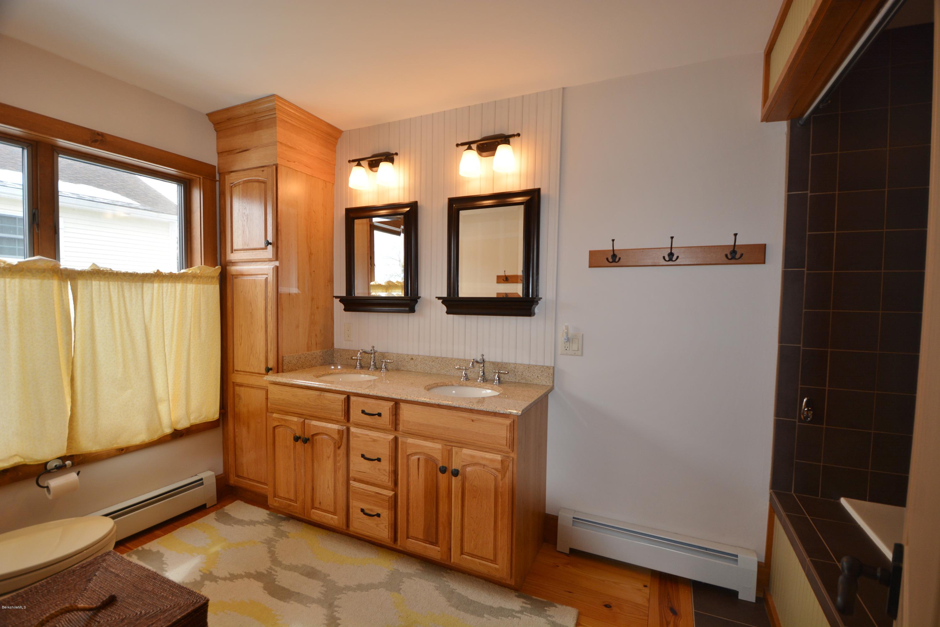9 Old Stagecoach Road Otis, MA 01029 - Photo 9 of 17 a bathroom with a sink a mirror and a shower